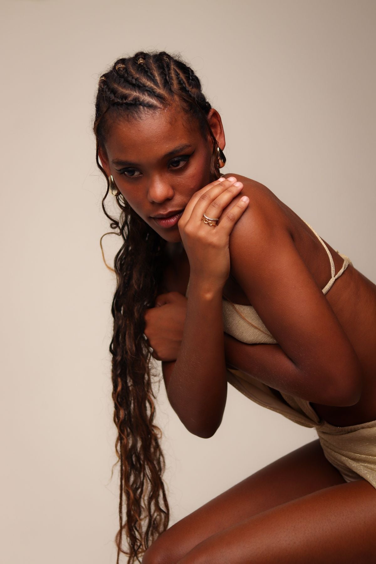 Adult woman in a cream outfit with braided hair — editorial inspiration